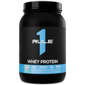 Black container of Rule 1 Whey Protein with blue accents on a white background